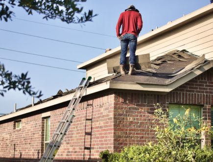 a man standing on the roof of a house