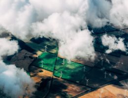 aerial photo of wind turbines near field