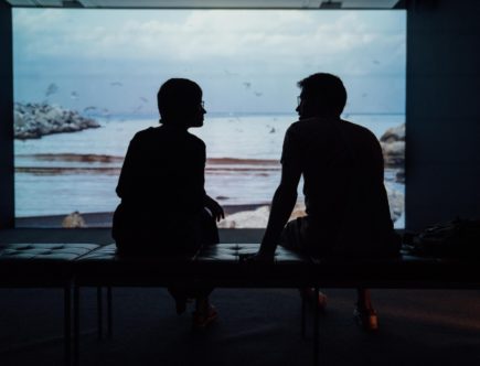 silhouette of man and woman sitting on ottoman