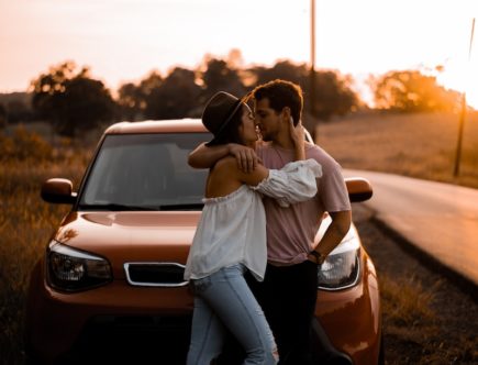 woman and man standing in front of vehicle