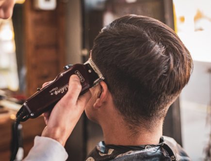 man in white dress shirt holding black dslr camera