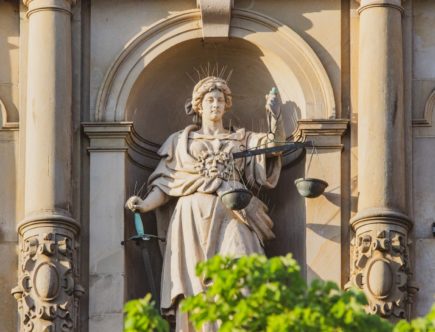 statue of man holding cross