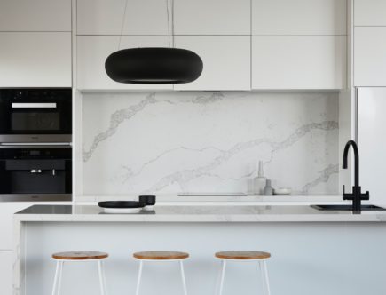 black round seat beside white wall