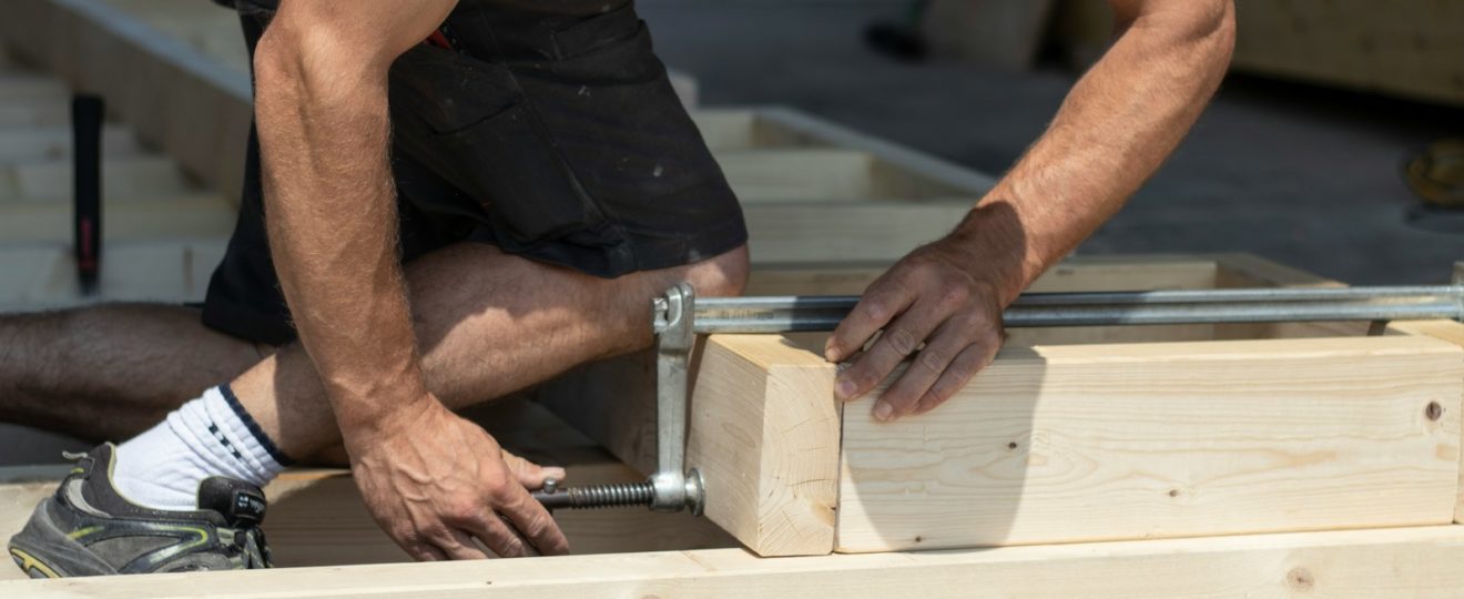 man holding gray metal hand tool